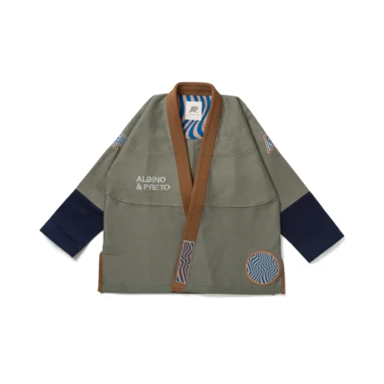 Albino & Preto Tranquility Gi in earth-tone colors, featuring a 450gsm pearl weave jacket and "Novo" cut twill pants, adorned with breath-flow patch artwork, designed for Brazilian Jiu-Jitsu practitioners.