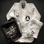 White RVCA Moya BJJ Gi with black embroidery and 450 GSM pearl weave fabric, displayed on a mannequin for jiu-jitsu training.